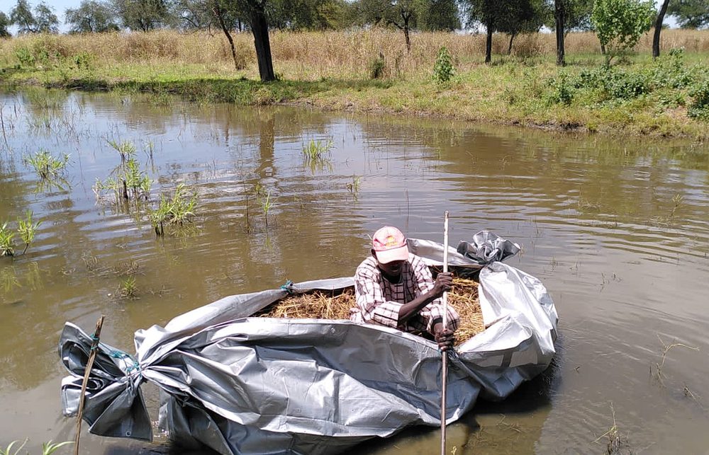 Hombre huyendo del conflicto en el Alto Nilo utilizando una balsa improvisada